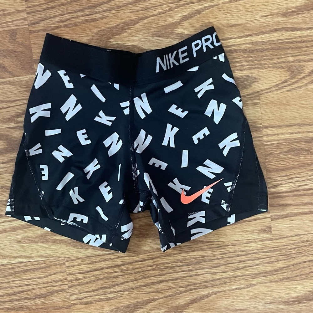 Nike pros with black and white letters size medium but fits like small